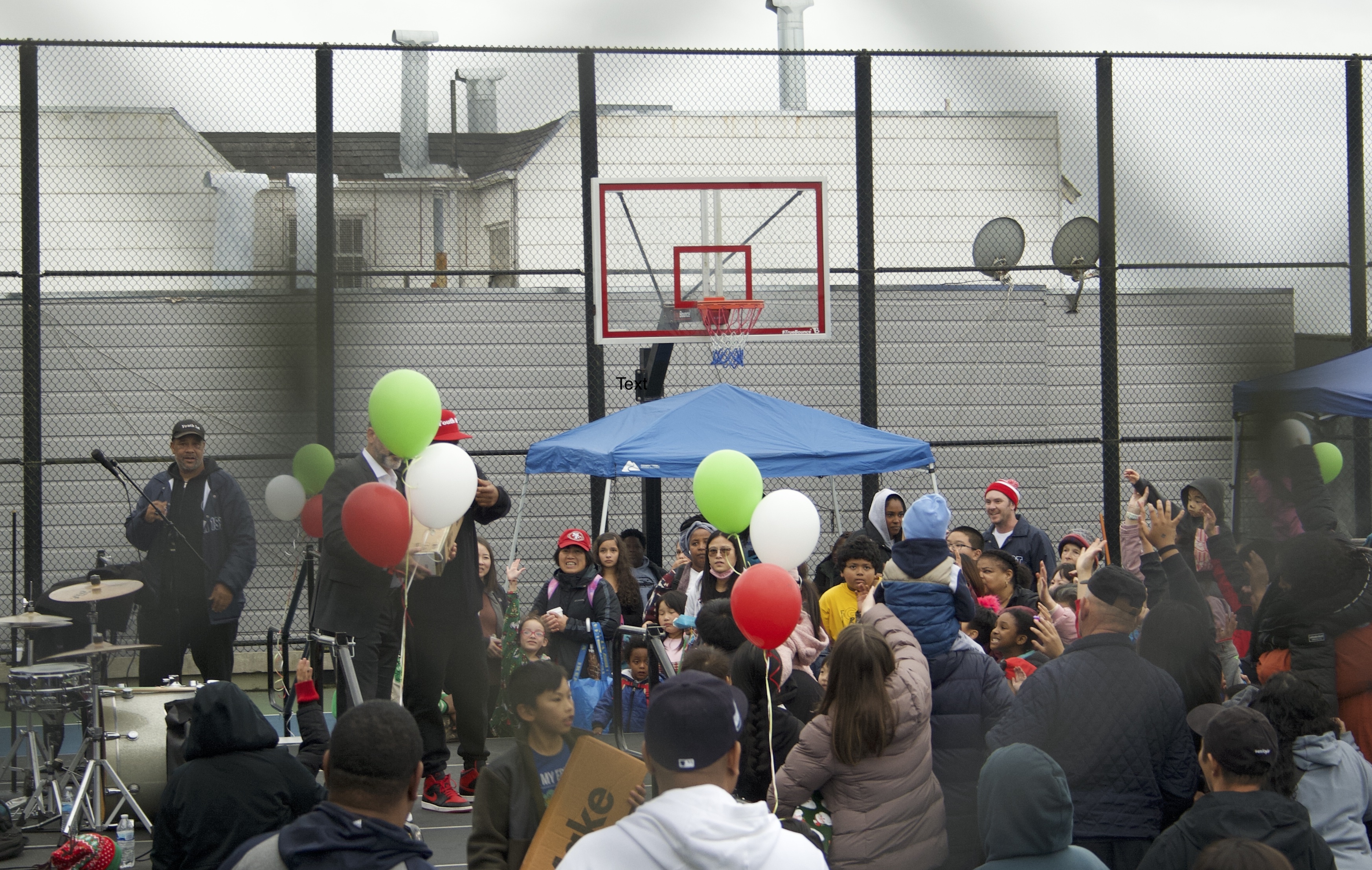 2024 Toy Drive Stage Kids through fence.