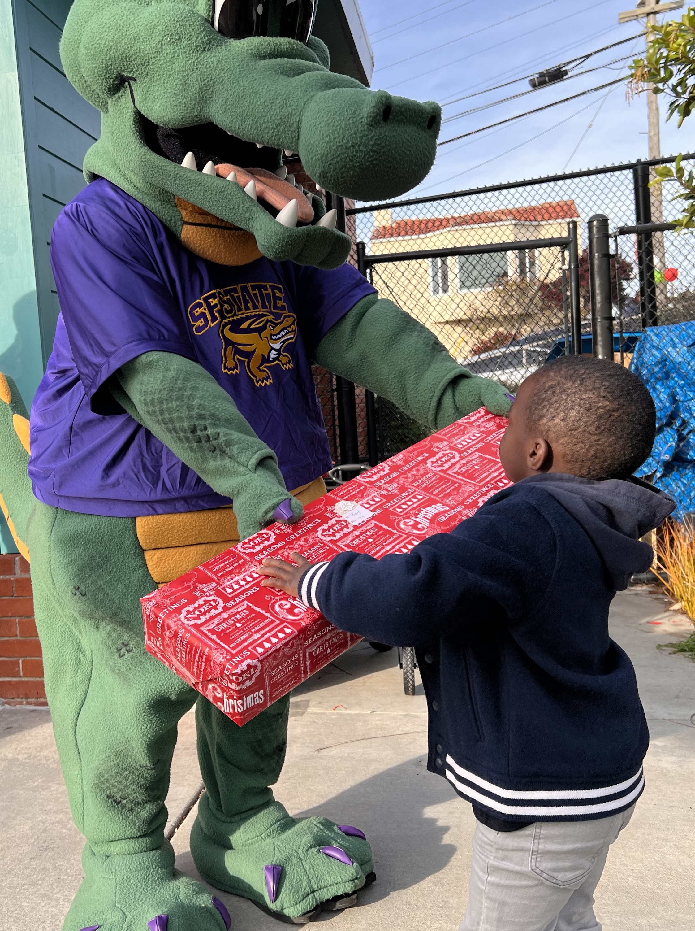 Toy Drive 2023 - Ali handing gift