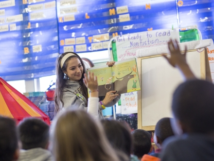 Student reading to class.